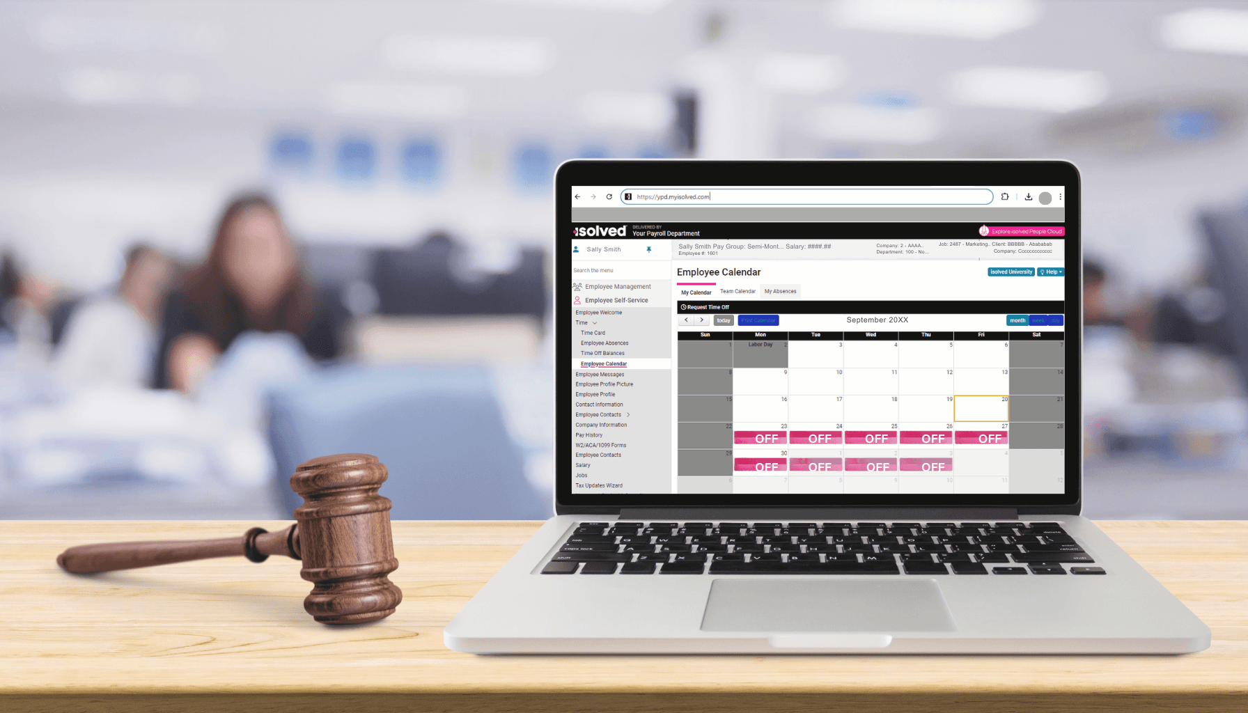 A laptop displays YPD's isolved employee calendar. isolved is a cloud-based payroll system that streamlines time-off requests, approvals, and tracking and ensures compliance with paid leave laws.